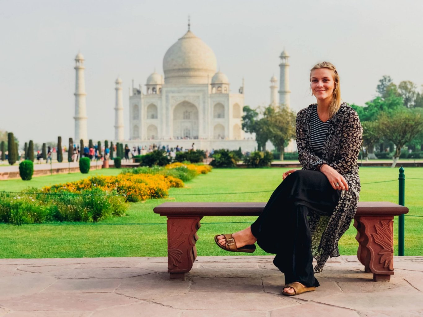 Girl sitting in front of the Taj Mahal, Agra, India