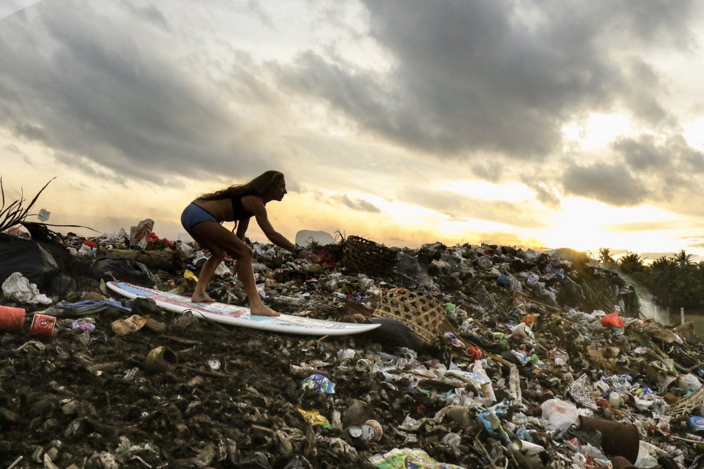 Surfing over rubbish in Bali