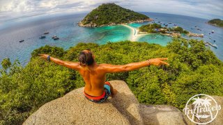 A guy sitting on a rock at the top of the viewpoint in Koh Nang Yuan 