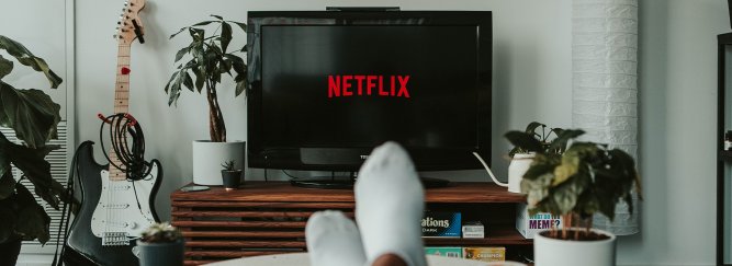 Person sitting with Feet up Watching Netflix on TV