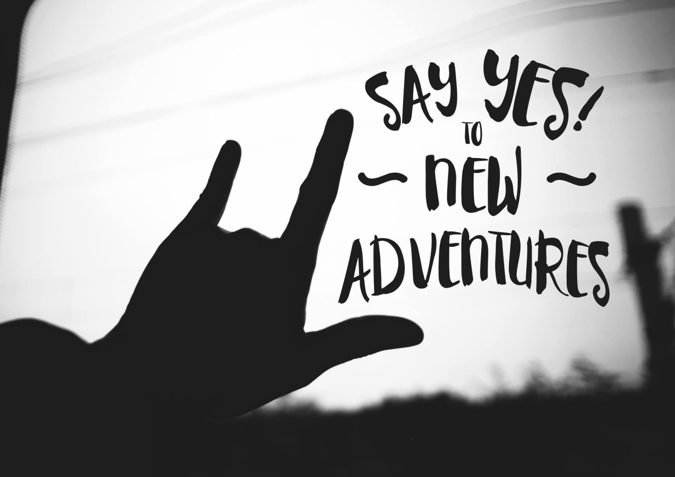 A quote that reads 'Say yes to new adventures' in black and white