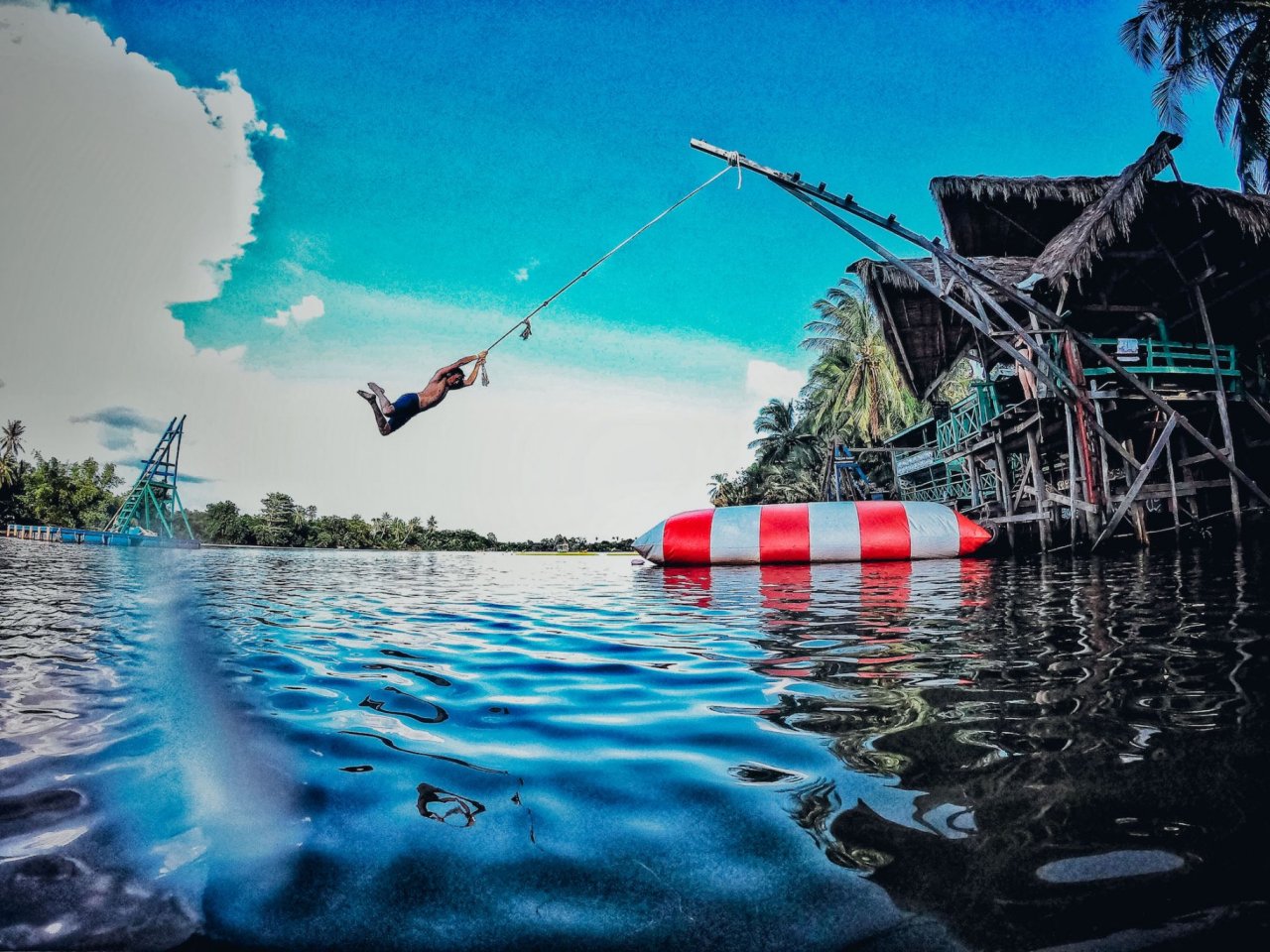 Rope Swing into River with large inflatable and over Water Bungalow