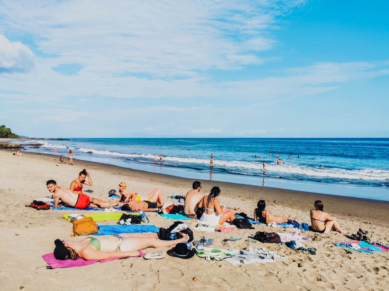 A group of people sunbathing on the beach.