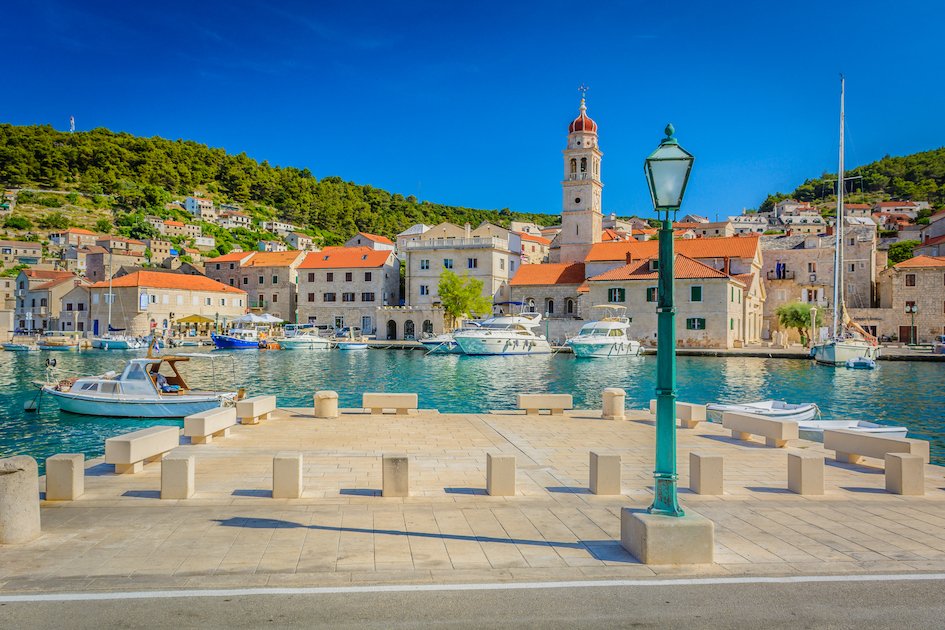 The picturesque island of Brac, Croatia with clear blue water and scenic houses along the waterfront