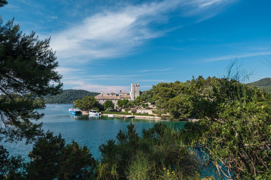 A scenic photo of Mljet National Park, with lush greenery and the turquoise water in view