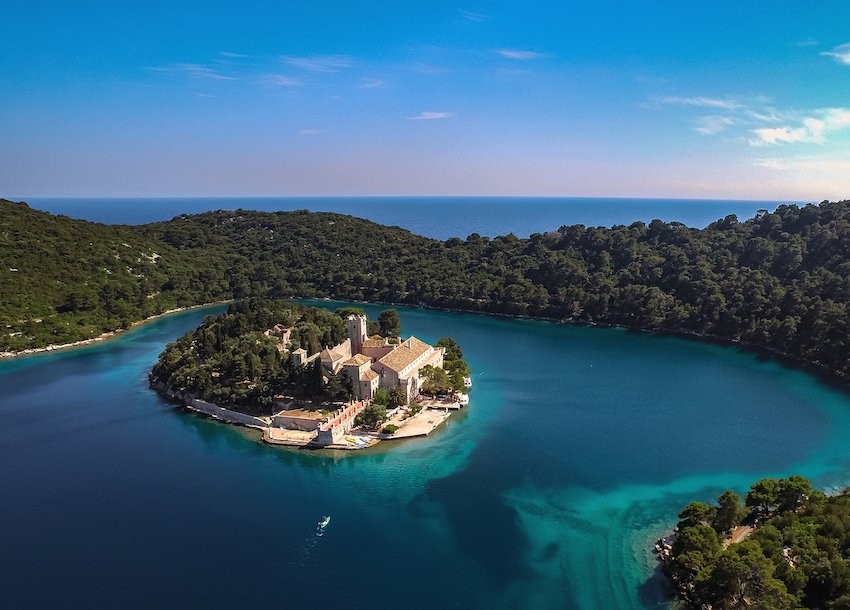 A stunning shot of Mljet, Croatia's National park with clear turquoise water and lush greenery  at sunset