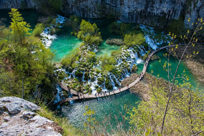 A stunning birds eye view shot of Plitvice falls, showing the bright clear turquoise water and trees at this national park in Croatia