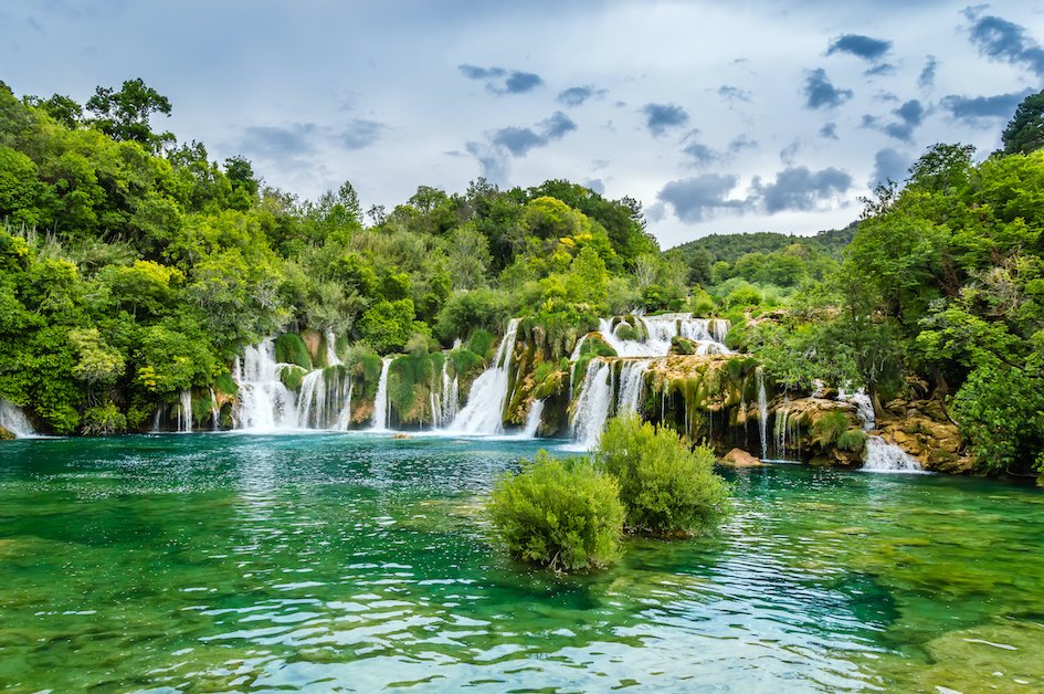 The stunning waterfalls in Plitvice Lakes, showing the luscious greenery and the bright turquoise water