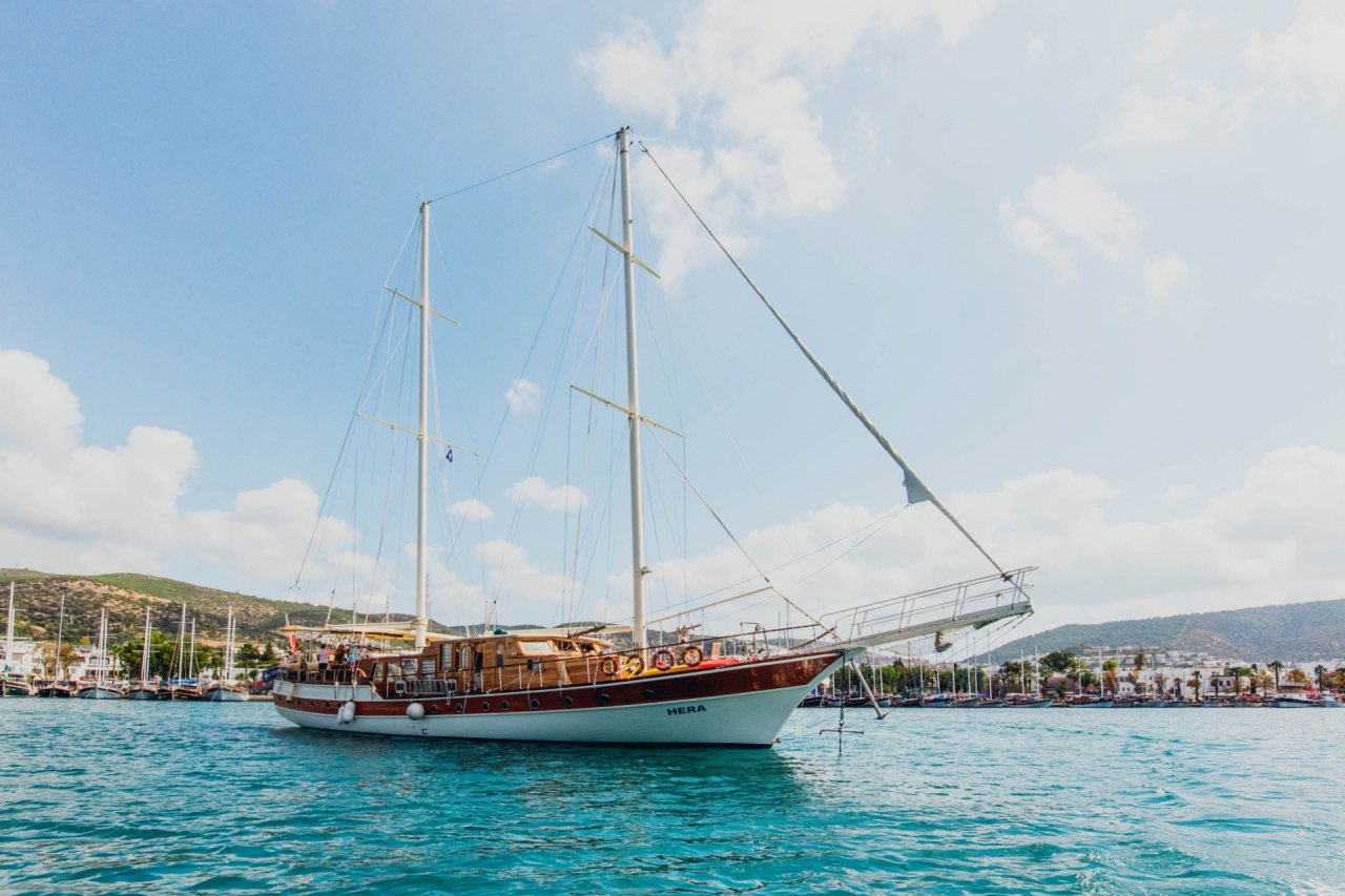 A sailing boat on calm blue water.