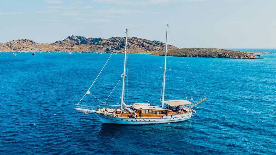 A shot of the sail boat in Greece sailing on the deep blue ocean