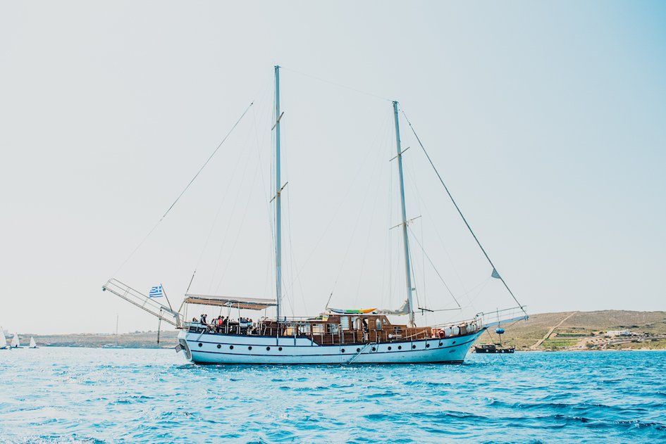 A shot of the sail boat in Greece sailing on the deep blue ocean
