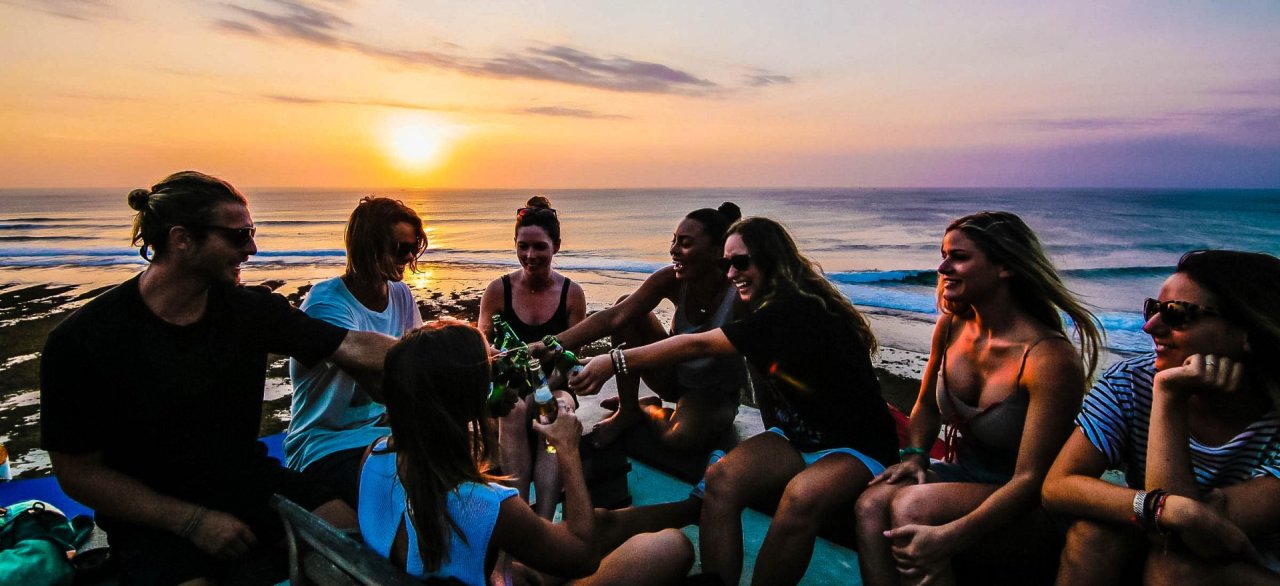 Group cheersing on boat during sunset