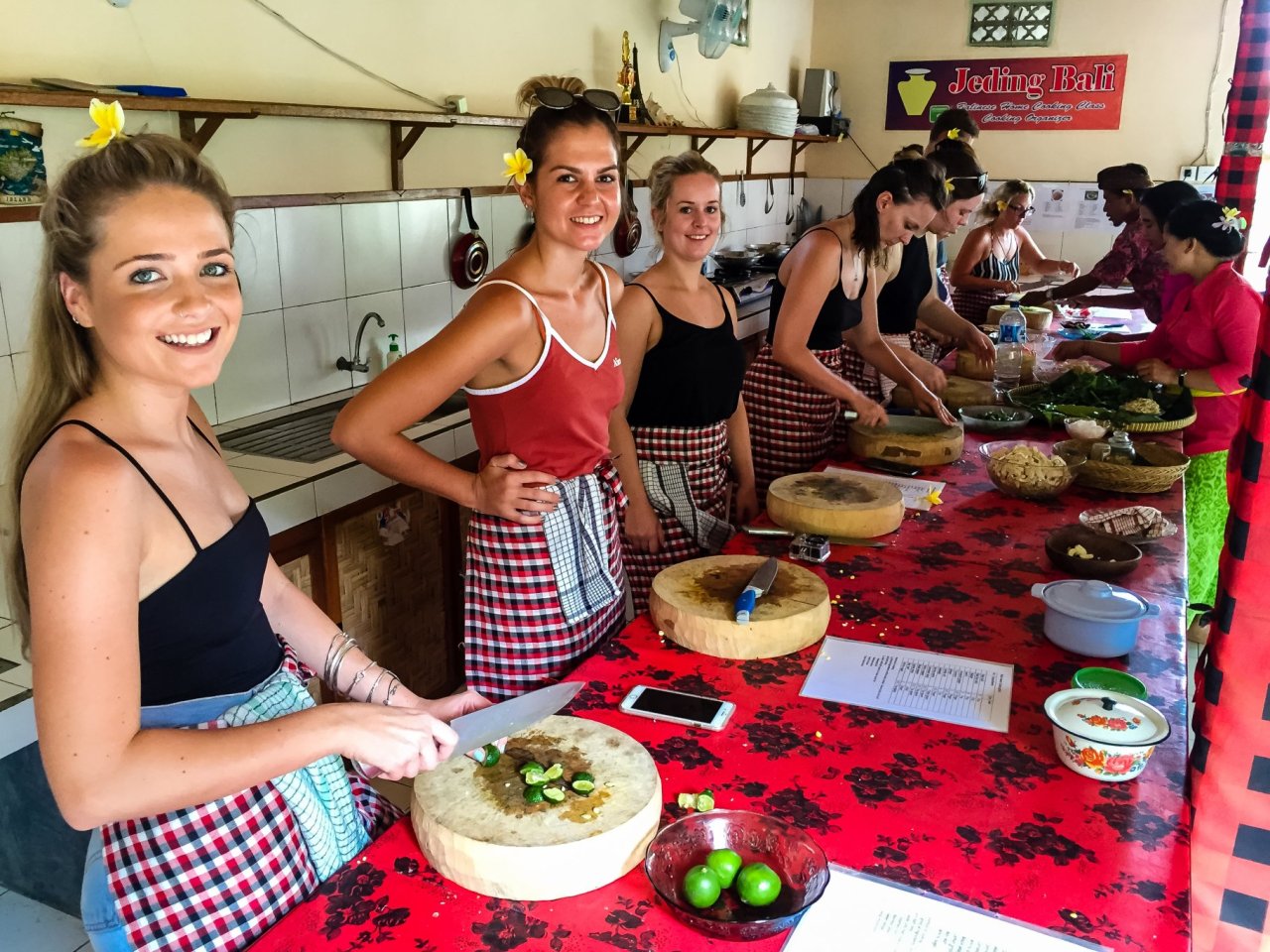 Group og girl travellers in kitchen at a Balinese cooking class