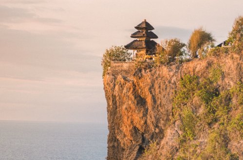 A shot of a gorgeous temple sitting at the edge of a cliff in Bali, Indonesia 