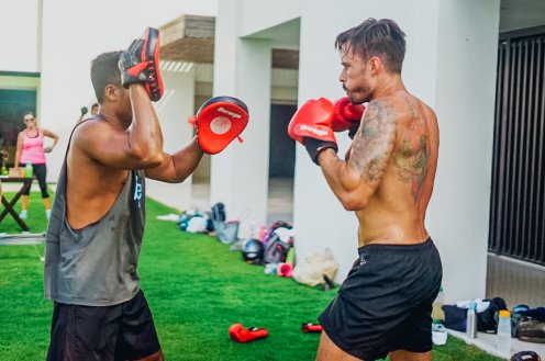 Two guys wearing boxing gloves at a boxing class in Bali, Indonesia 
