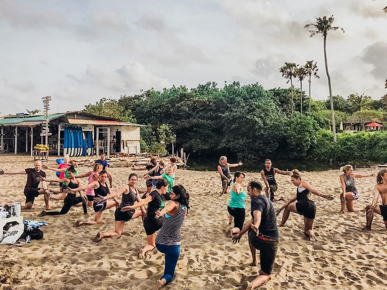 A group taking part in a HIIT workout on the beach in Bali, Indonesia 