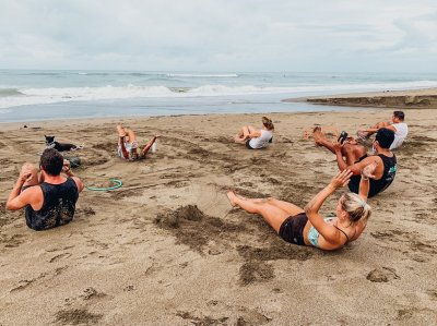 A group taking part in the HIIT workout on the beach in Bali, Indonesia 
