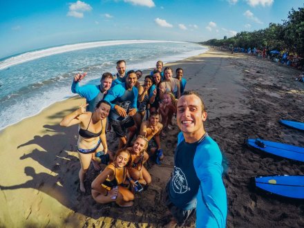 A group taking a selfie at the beach after surfing in Bali, Indonesia