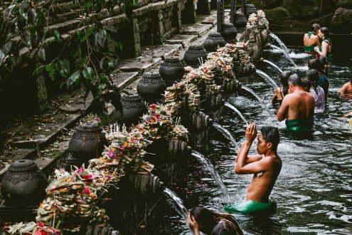 Men at a traditional local village in Bali, Indonesia in the water