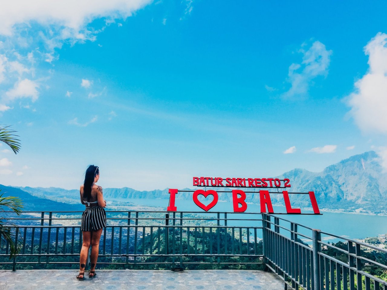 A girl admiring the view overlooking Mount Batur in Bali Indonesia
