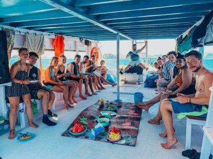 A group on the boat to the Komodo Islands enjoying lunch on the deck in Indonesia 
