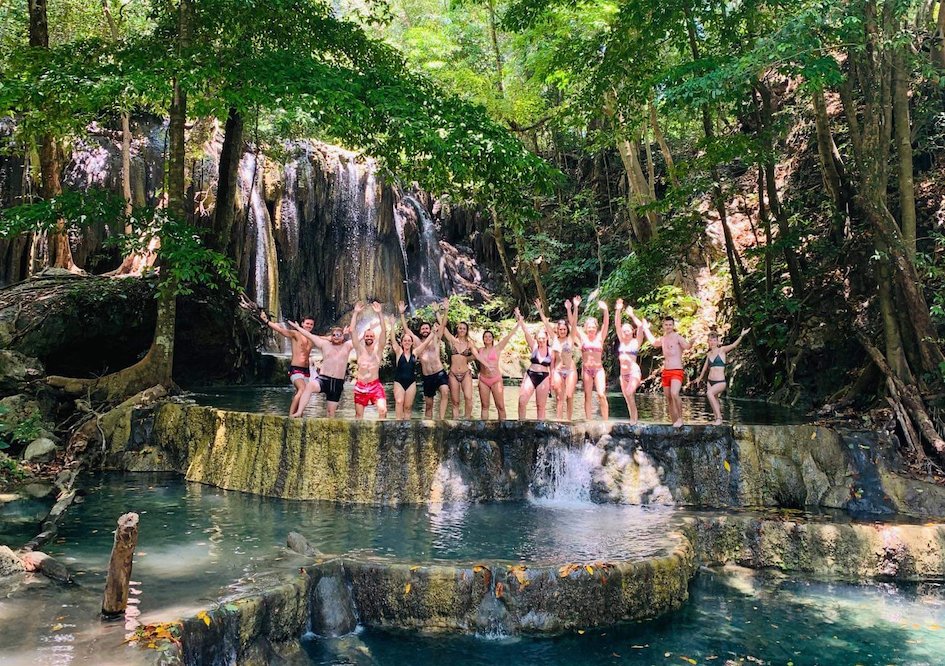 A group picture on Mojo Island at the serene waterfall 