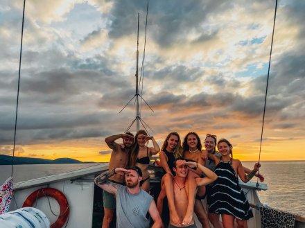 A group on the boat at sunset sailing to the Komodo Islands in Indonesia 