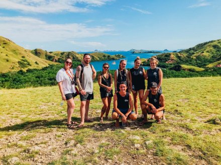 A group picture showing the surrounding lush green landscape while island hopping through the Komodo Islands in Indonesia 
