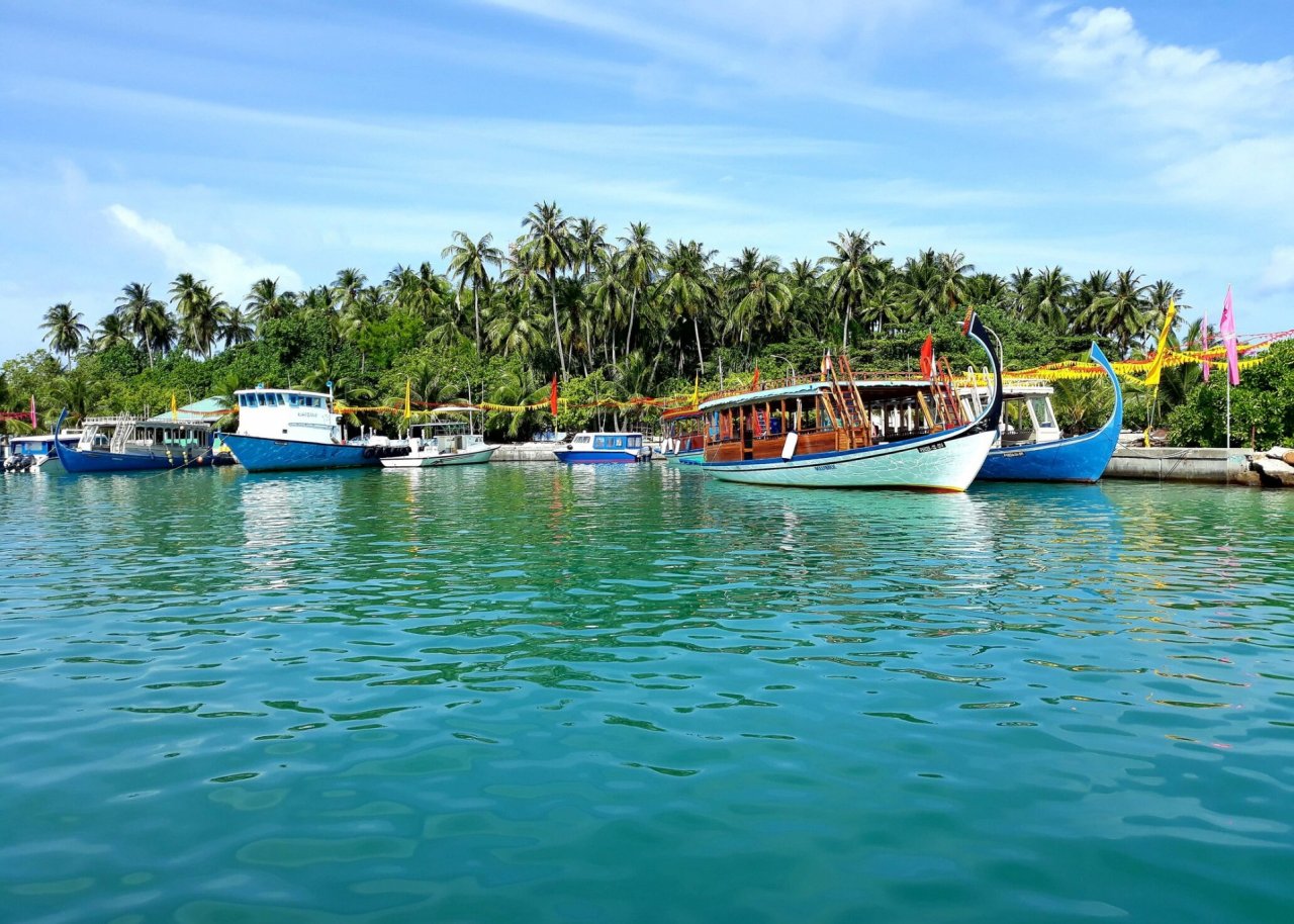 A shot of the fishing boats on the turquoise water in the Maldives 