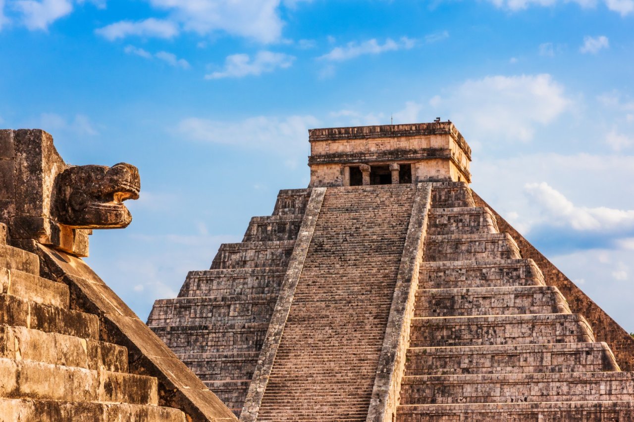 A scenic image of The Mayan Ruins of Chichen Itza in Mexico with a blue sky in the background 