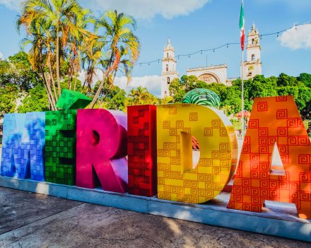 A shot of a colourful rainbow sign reading Merida in Mexico 
