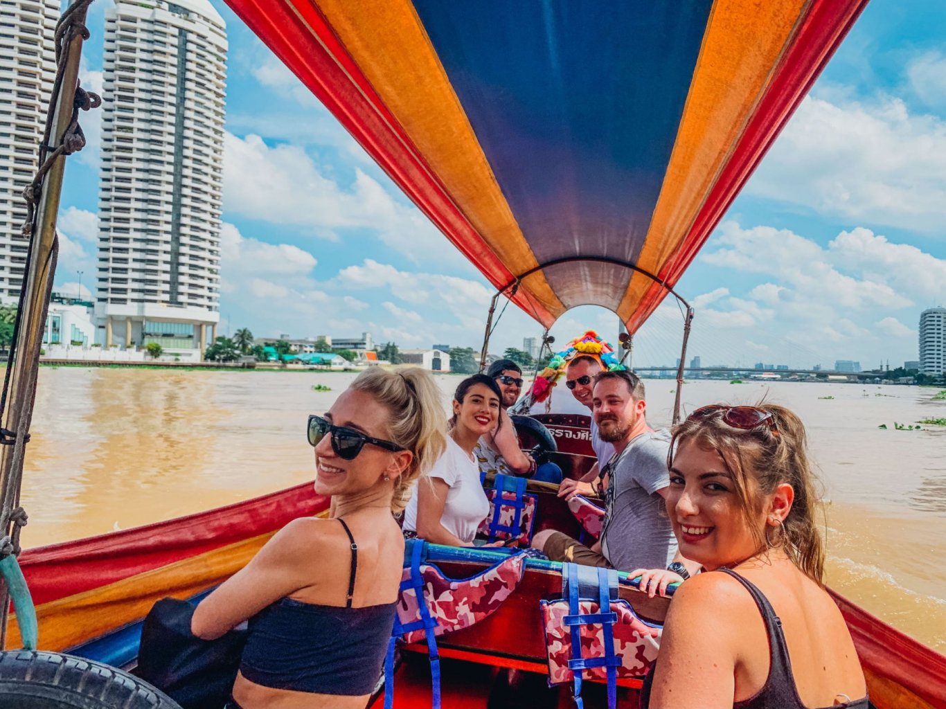 Group on a colourful long tail boat ride on Chao Phraya River