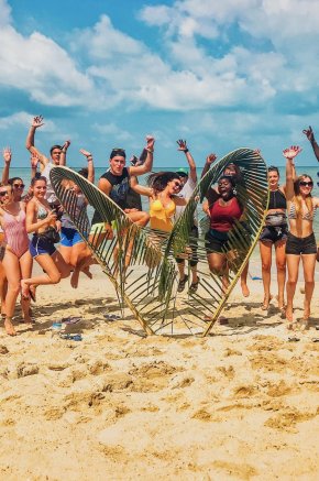 A group jumping in the air at bottle beach Koh Phangan Thailand