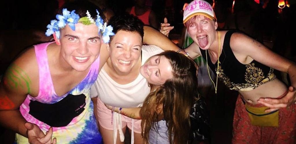 4 travellers smiling at full moon party -Thailand