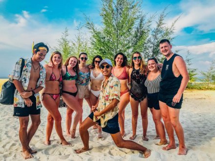 A group picture on a picturesque beach in Thailand.