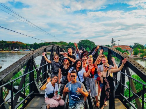 A happy group photo at the idyllic bridge on river Kwai
