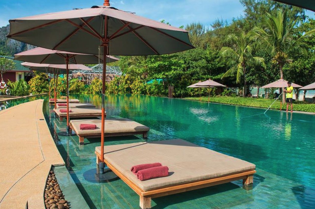 A gorgeous shot of the turquoise pool and wide sun beds in the shallow end at the hotel in Koh Phi Phi, Thailand