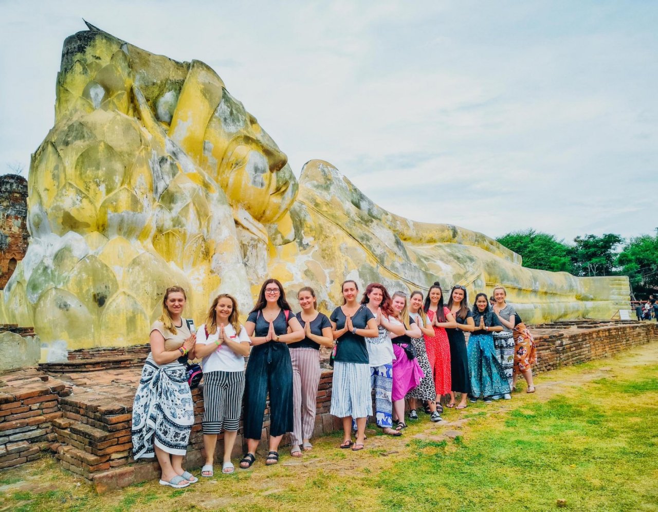 A serene group photo beside the reclining buddha in Ayutthaya
