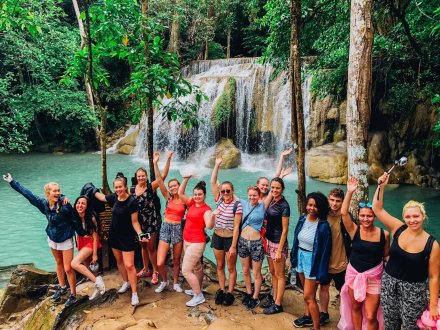 A group photo at the waterfall in Erawan falls Thailand 
