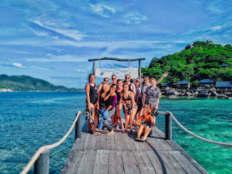 A group photo by turquoise water in Koh Tao