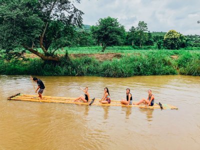 A group on a bamboo raft along the river in Northern Thailand 