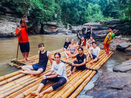 A group photo on the bamboo raft along the river in Northern Thailand 