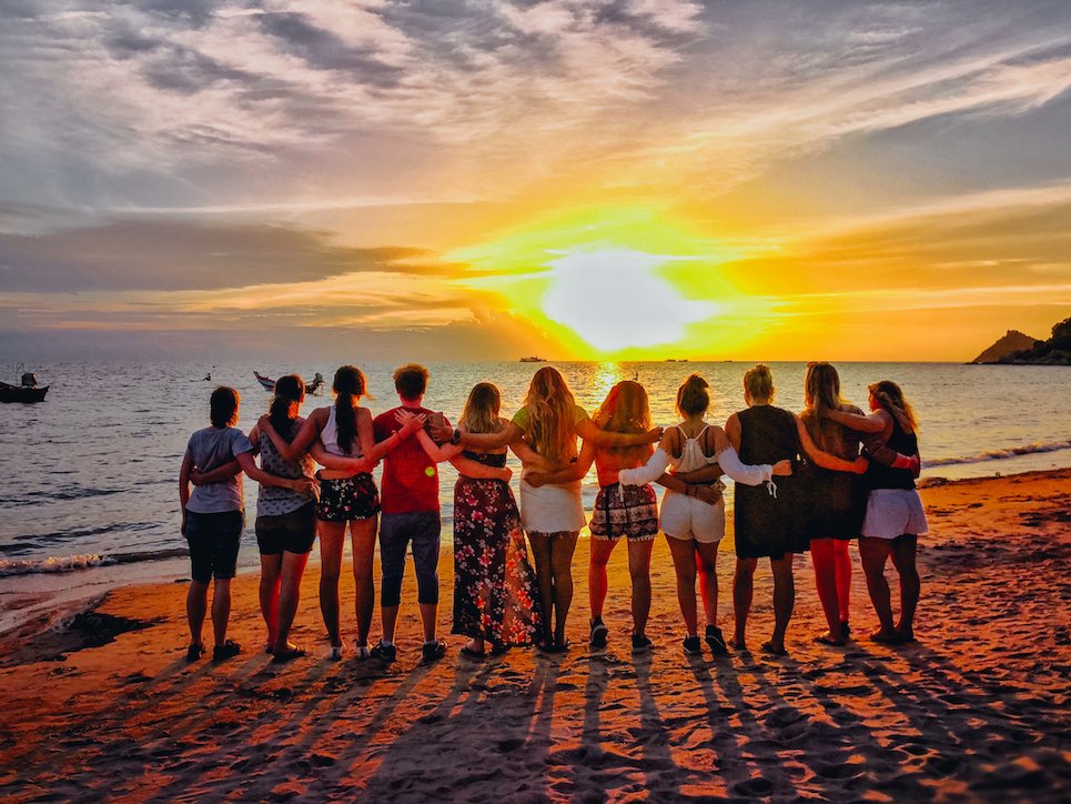 A group photo at sunset on the beach in Thailand 