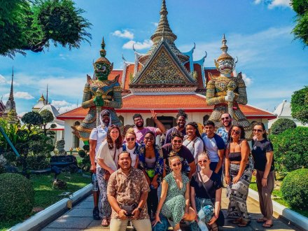 A group photo outside of Wat Pho in Bangkok Thailand on a sunny day