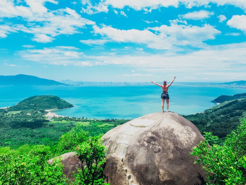 Girls standing on rock overlooking view in Vietnam
